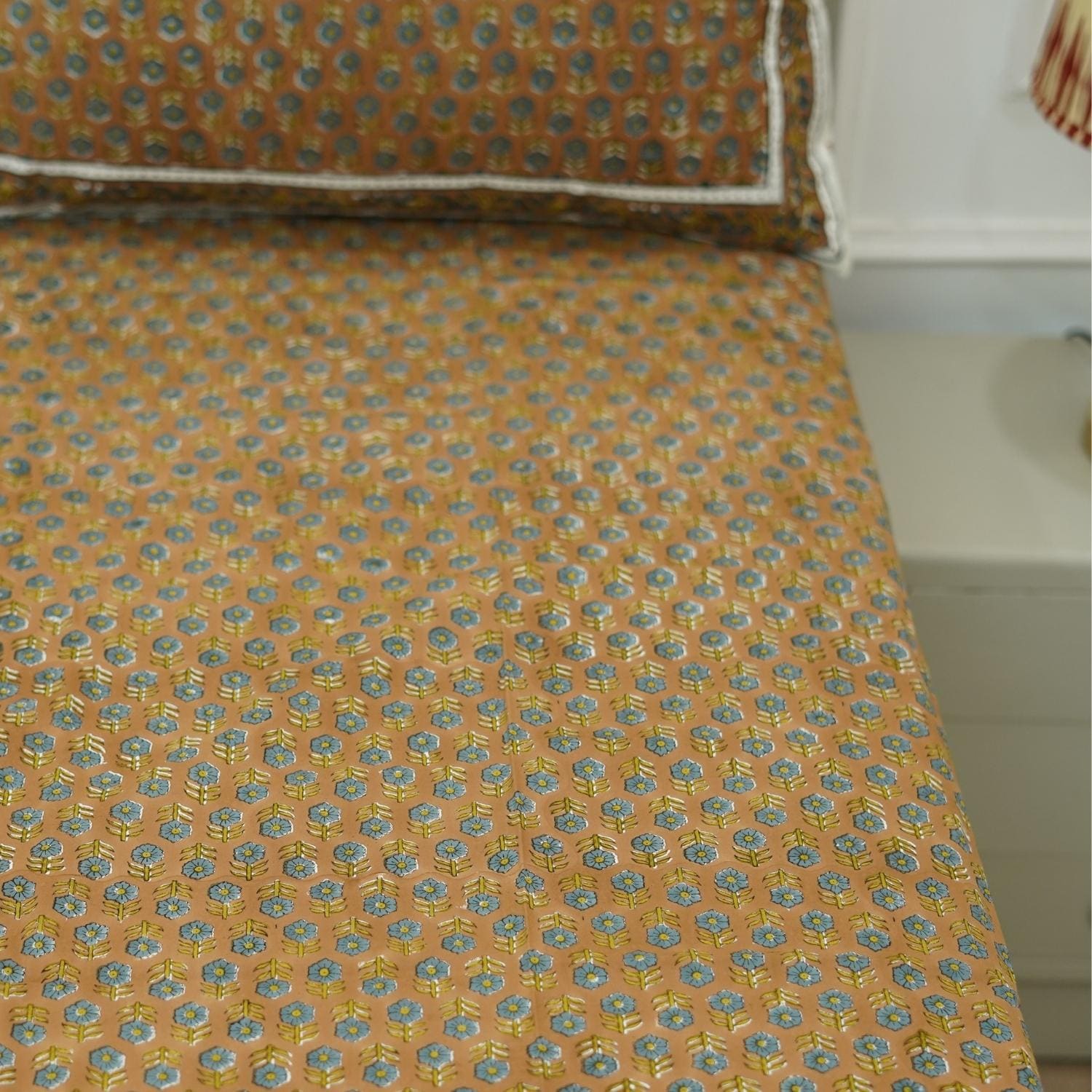 The delicate charm of block printing shines in this cotton bedsheet. Its floral design and pillow covers evoke rustic elegance, perfect for cozy homes with a handmade heart.