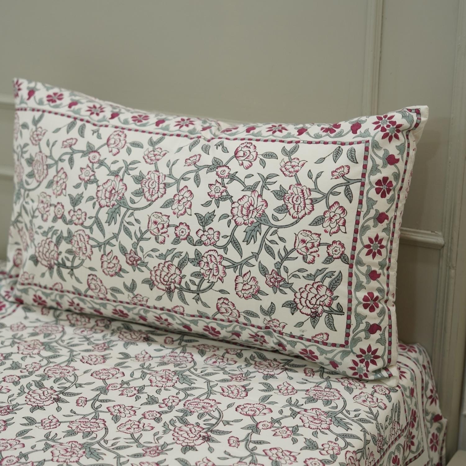 Floral patterned pillow and bedspread that are Hand block printed cotton bedsheet with floral design and matching pillow covers.