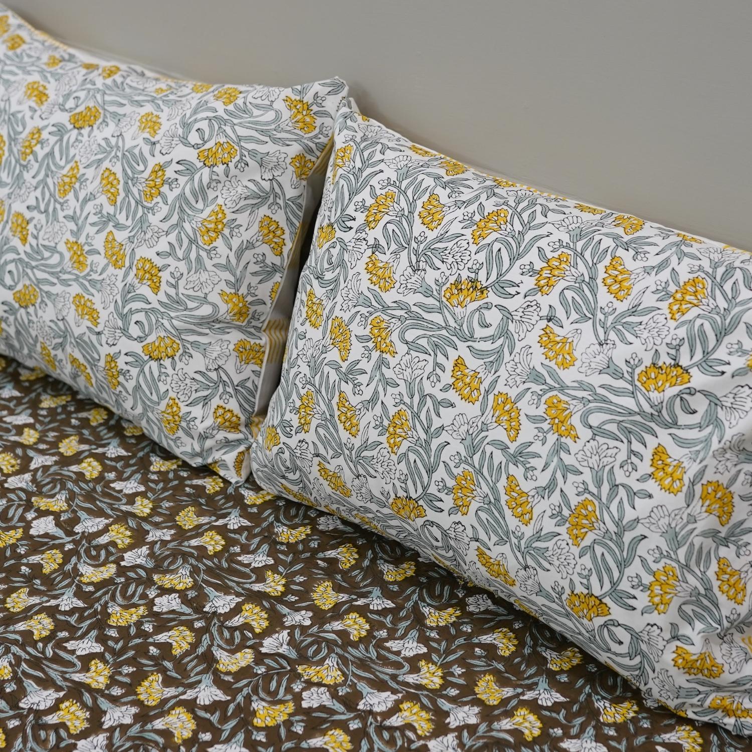 Each motif on this cotton bedsheet is hand block printed using wooden blocks, ensuring every set is one-of-a-kind. Its floral patterns and soft touch make it ideal for dreamy, earthy interiors.