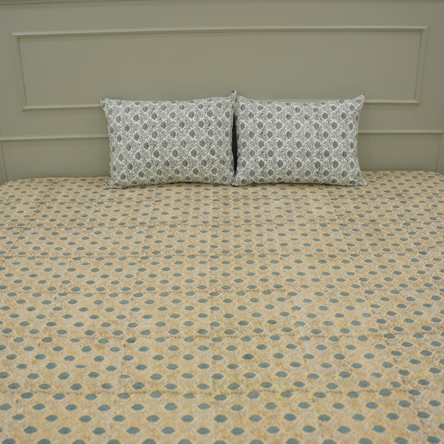 Discover the richness of Indian craftsmanship with this handmade cotton bedsheet and pillow cover. Wooden blocks imprint delicate floral patterns, creating a rustic yet elegant aesthetic. A beautiful blend of heritage and comfort for any space.