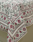 Floral patterned bedsheet with red and green design on a neutral background
