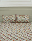 Let your bedroom bloom with handcrafted beauty. This hand block printed bedsheet on pure cotton, paired with pillow covers, captures floral artistry in soft tones. Each piece echoes heritage and the skill of artisans.