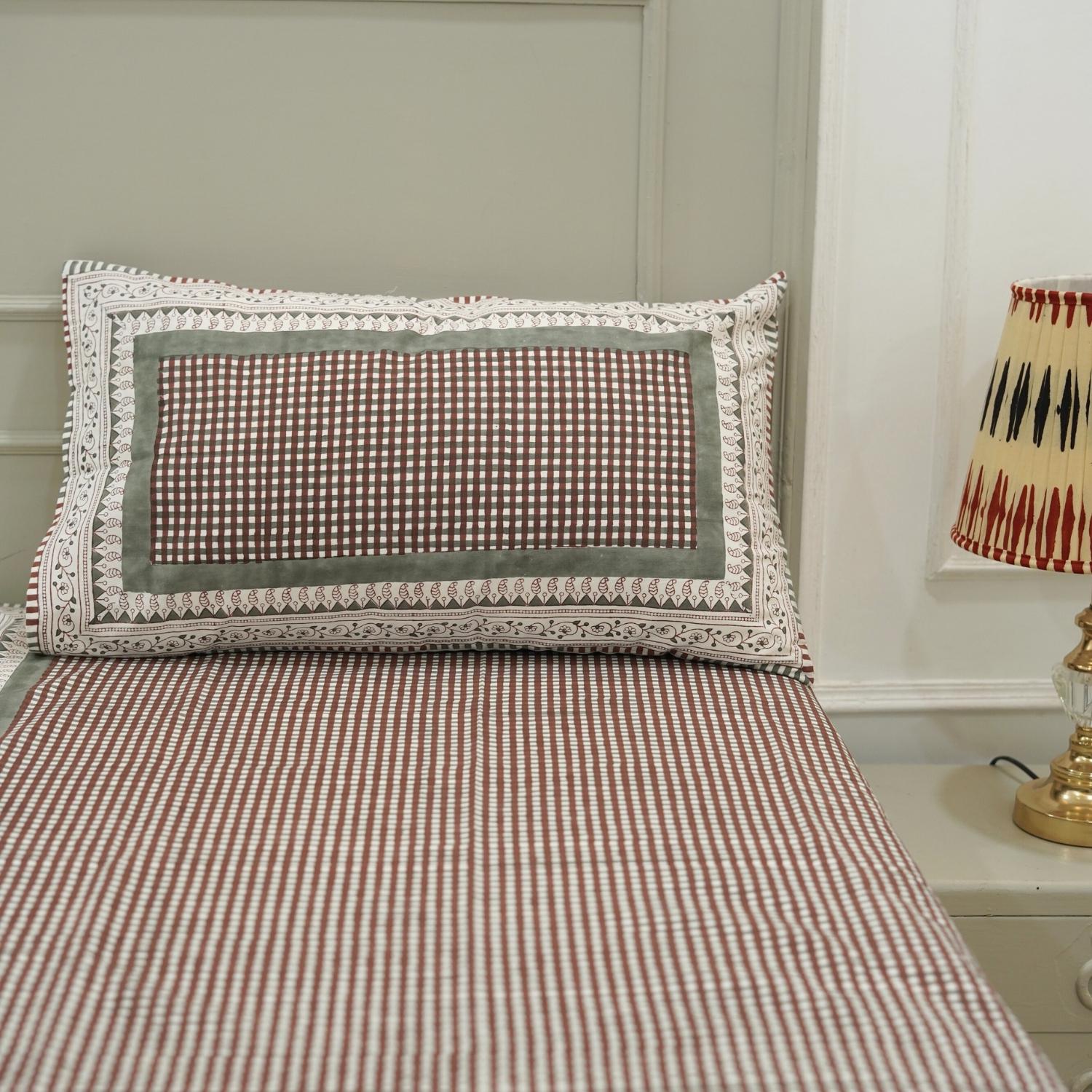 Timeless and elegant, this cotton bedsheet features floral block prints made by hand. The matching pillow covers complete a look of handcrafted luxury in a cozy, grounded palette.