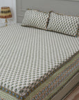 A beautifully handmade bedsheet featuring floral hand block prints. Made from breathable cotton and paired with pillow covers, it adds warmth and handmade soul to your bedding.