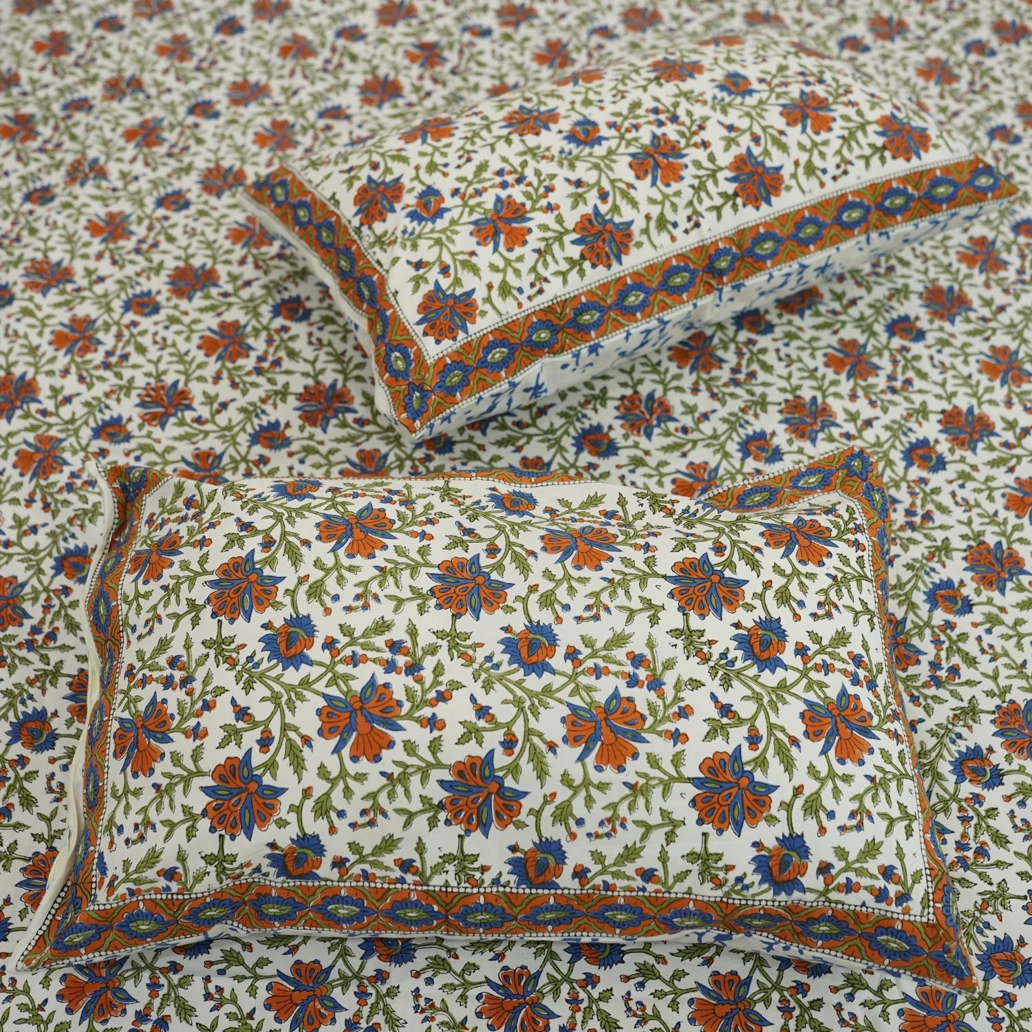 Discover the richness of Indian craftsmanship with this handmade cotton bedsheet and pillow cover. Wooden blocks imprint delicate floral patterns, creating a rustic yet elegant aesthetic. A beautiful blend of heritage and comfort for any space.