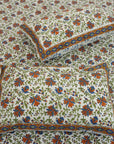 Discover the richness of Indian craftsmanship with this handmade cotton bedsheet and pillow cover. Wooden blocks imprint delicate floral patterns, creating a rustic yet elegant aesthetic. A beautiful blend of heritage and comfort for any space.
