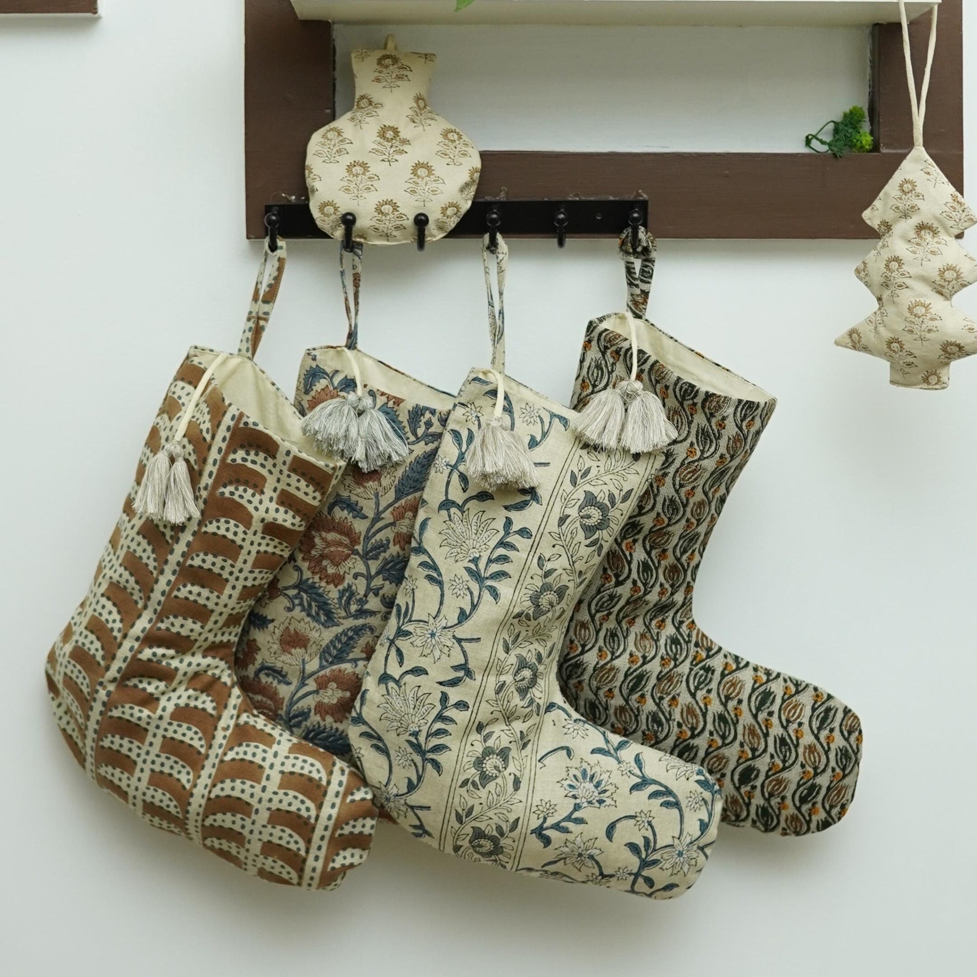 Decorative stockings with intricate patterns hanging on wall.