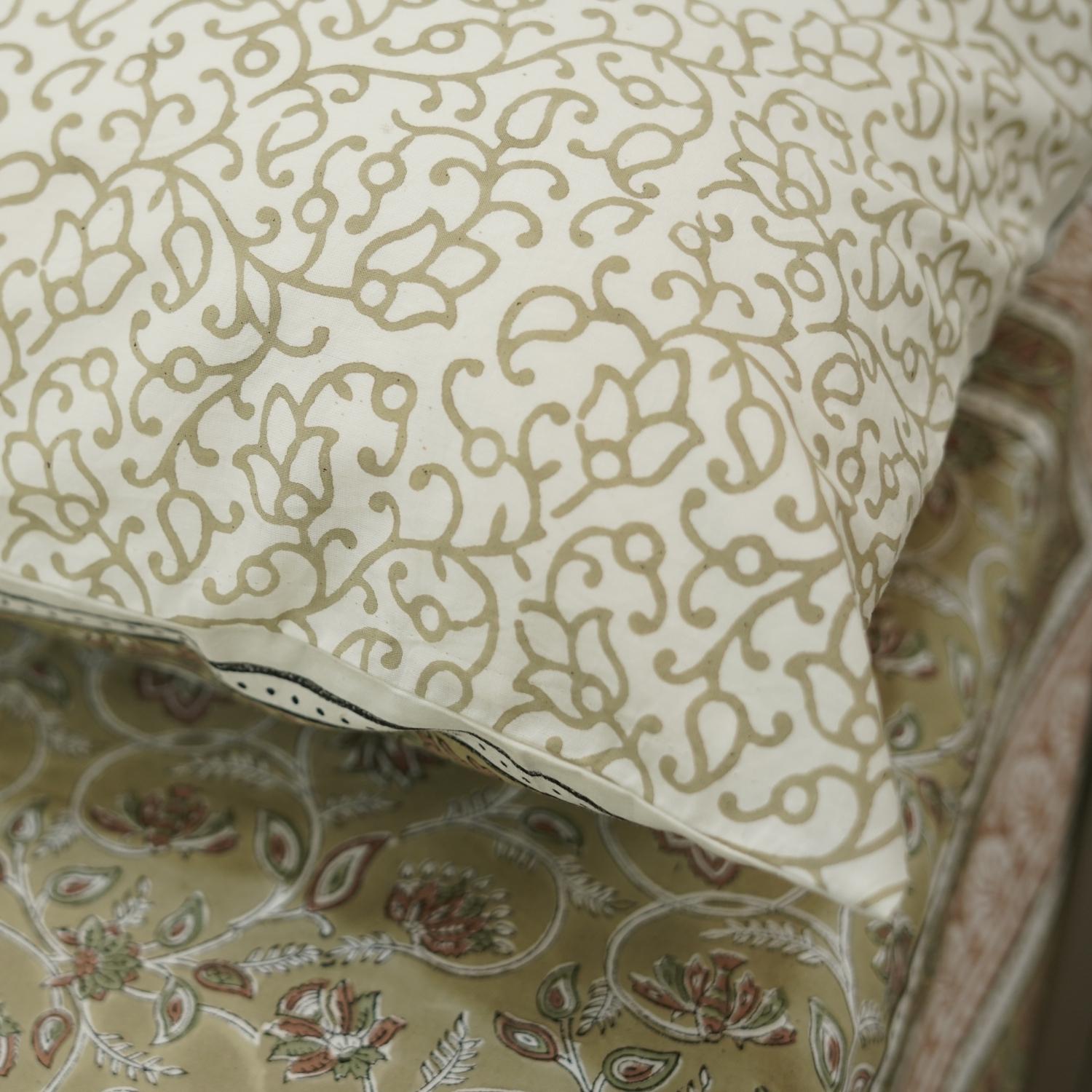 Patterned bedsheet with intricate designs on a bedspread