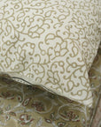 Patterned bedsheet with intricate designs on a bedspread