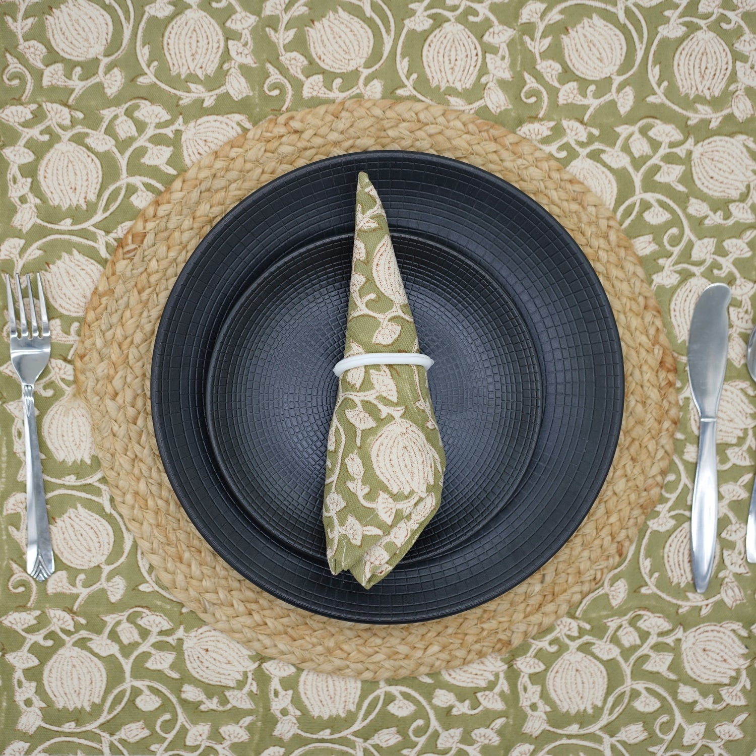 Handcrafted block print green napkin folded on a cozy dining table