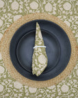 Handcrafted block print green napkin folded on a cozy dining table