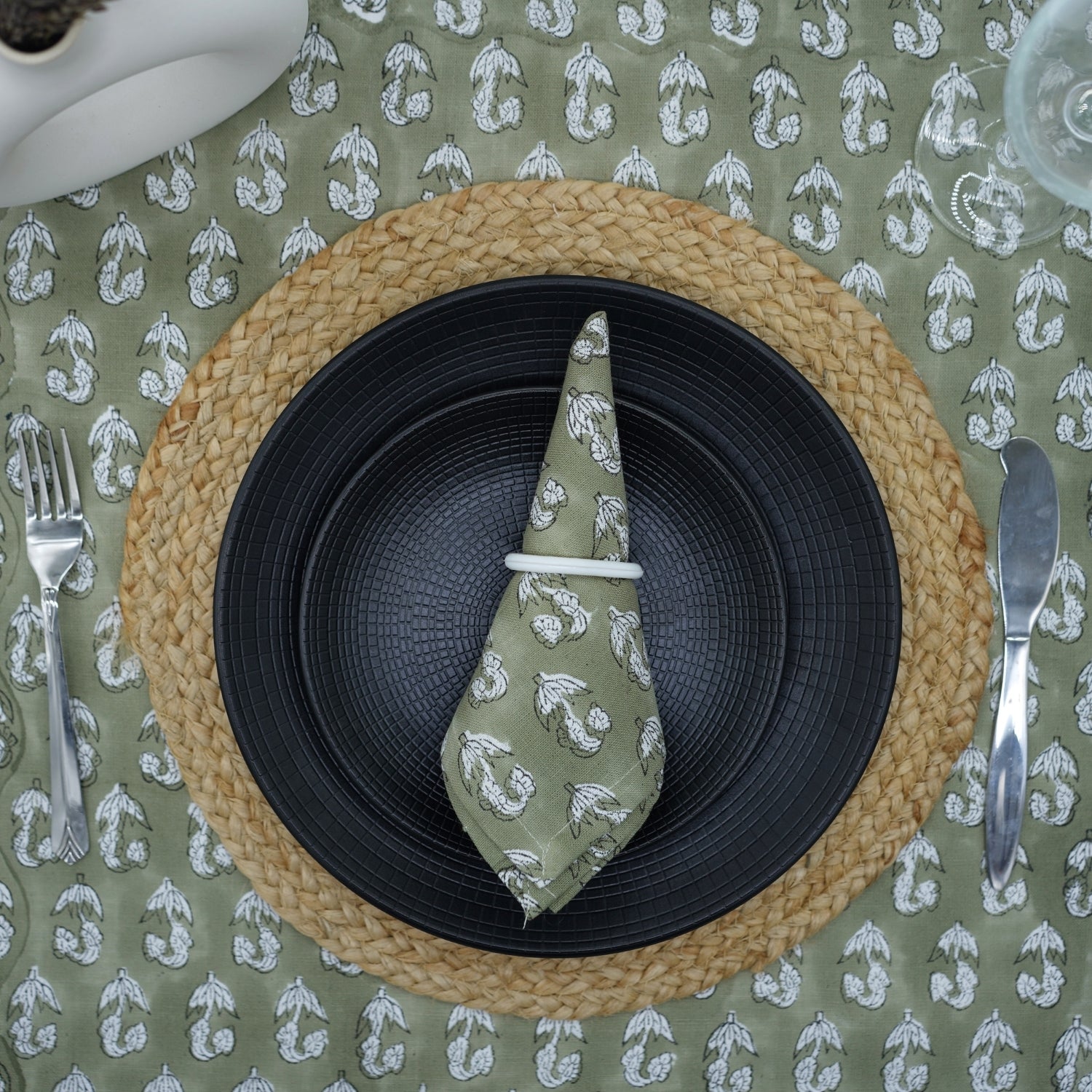 Block printed green napkin beautifully set on a dining table