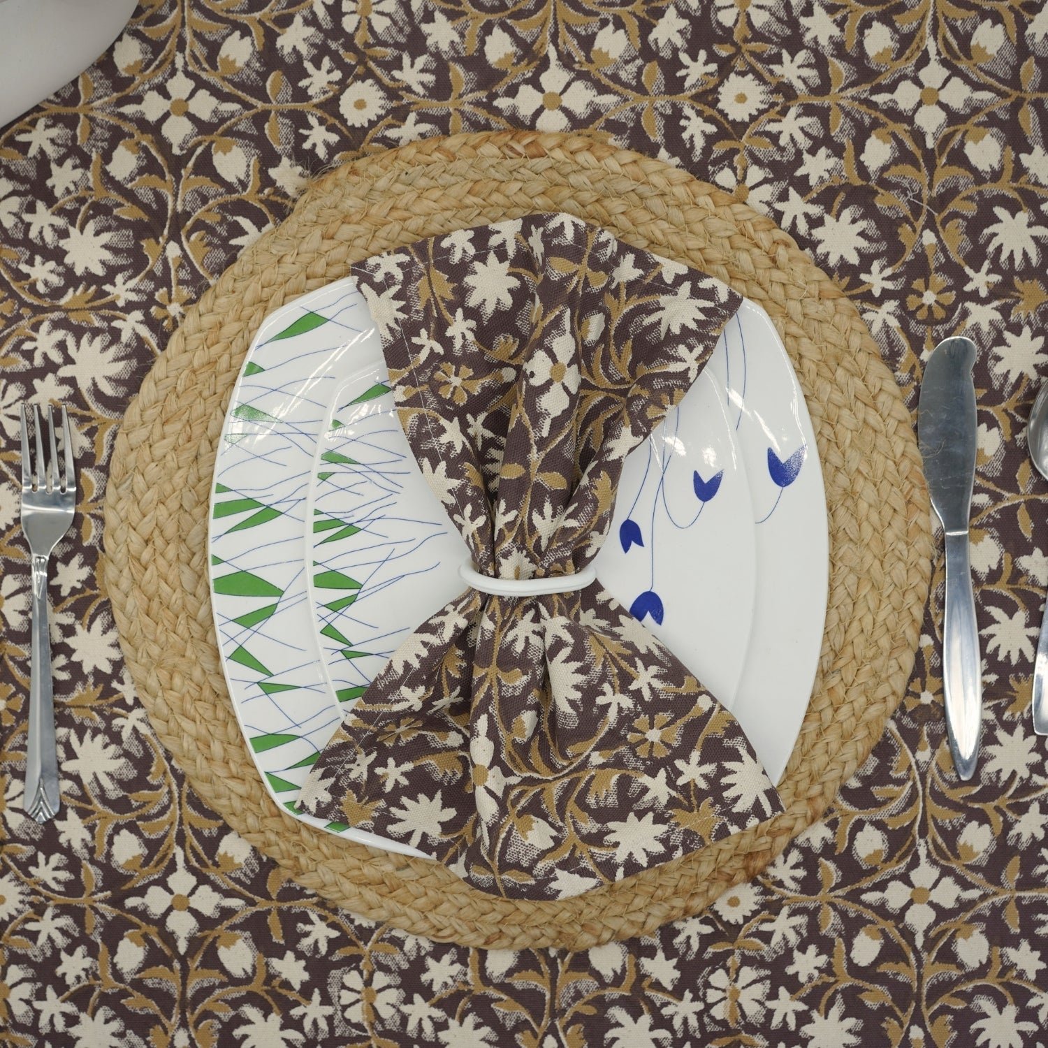 Handcrafted brown napkin set with floral block print on a dining table