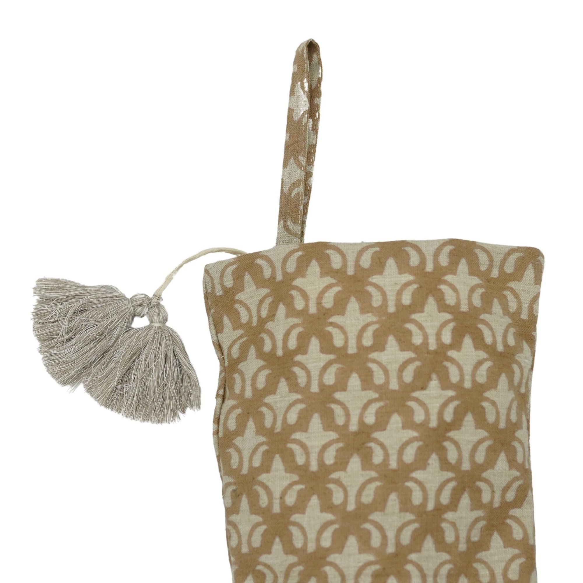 Patterned bag with tassel on white background.