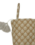 Patterned bag with tassel on white background.