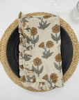 Beige block print frill napkin on a cozy dining setup.