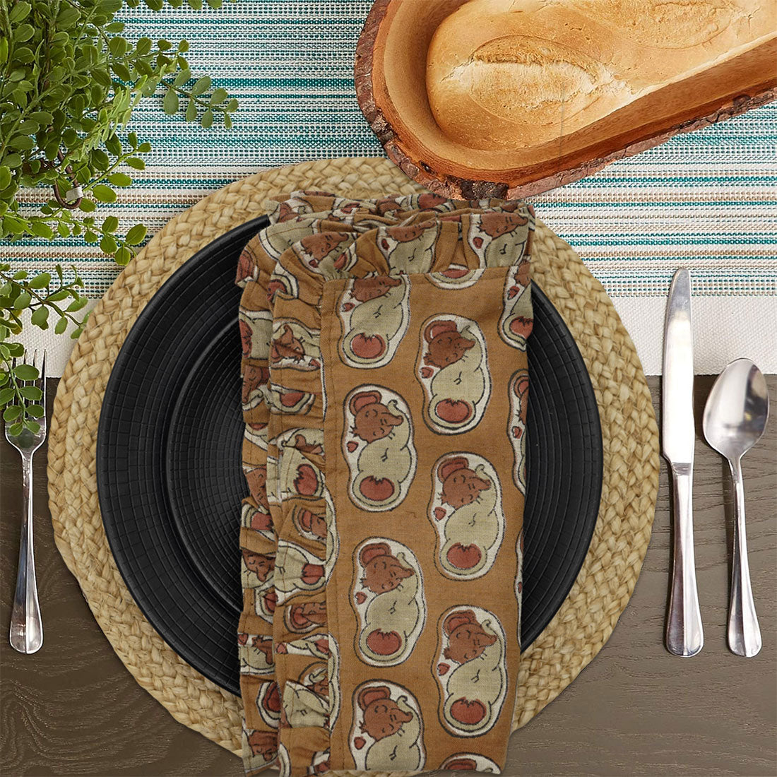 Table set with block print frill napkin featuring elephant design.