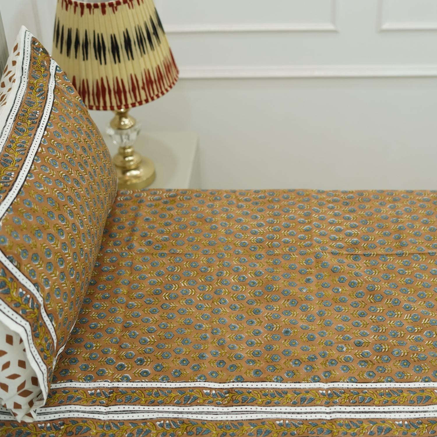 Make a subtle statement with our hand block printed cotton bedsheet set. Featuring timeless floral motifs and soft, breathable fabric, it transforms your bedroom into a peaceful haven.