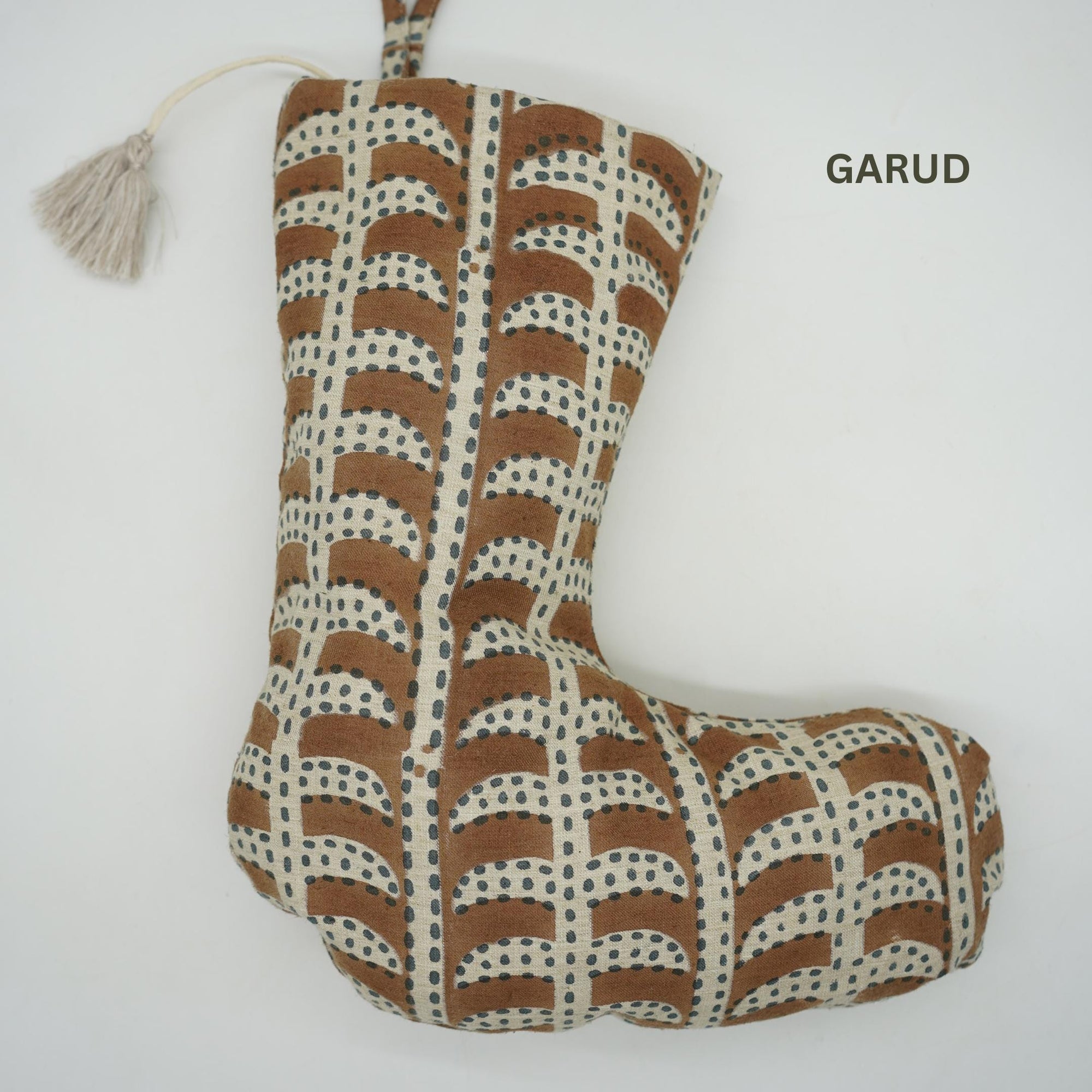 Brown stocking decorative pillow with beige pattern, branded 'GARUD'.