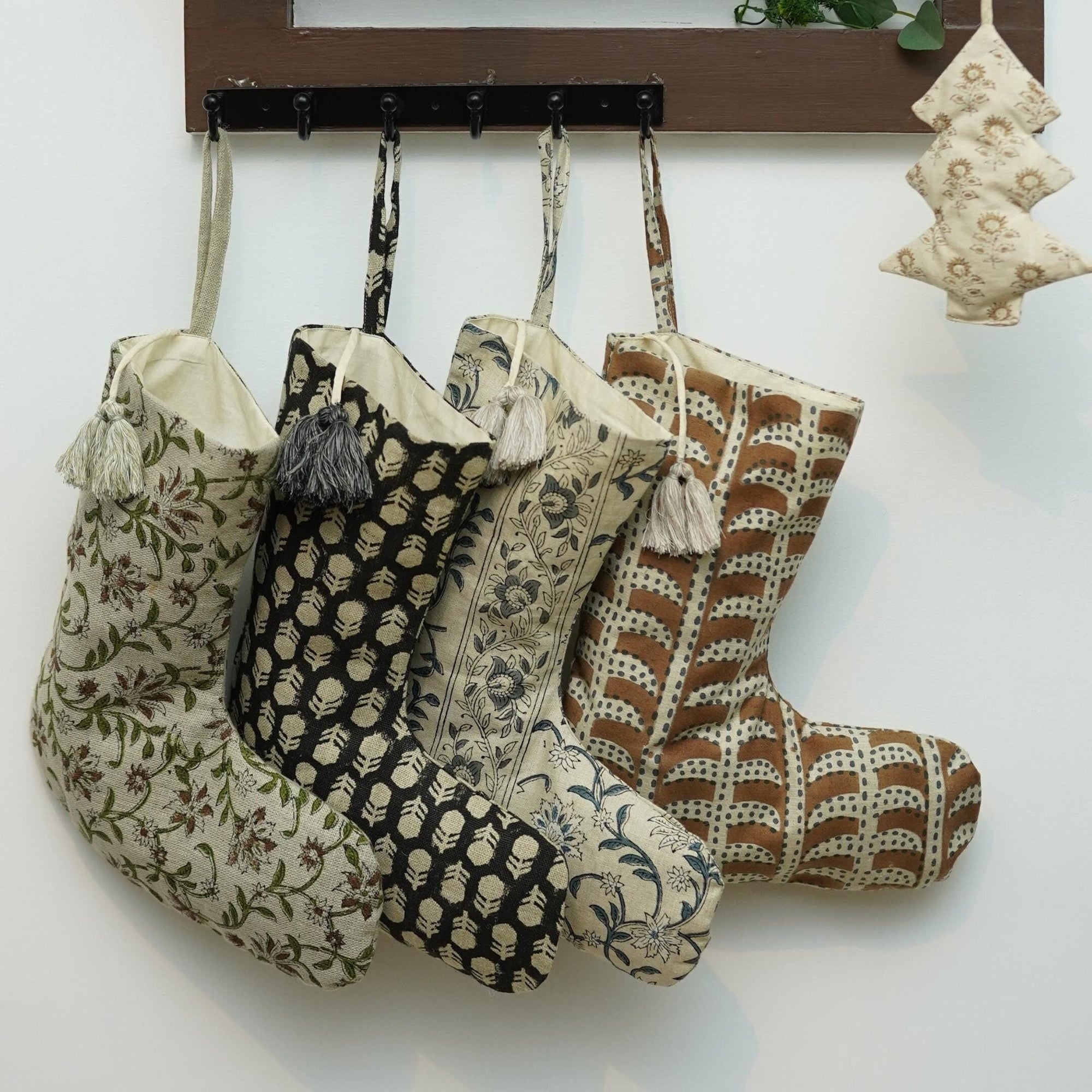 Set of patterned stockings hanging on wall hook.