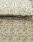 Floral patternedbed sheet with a matching pillow on a neutral background