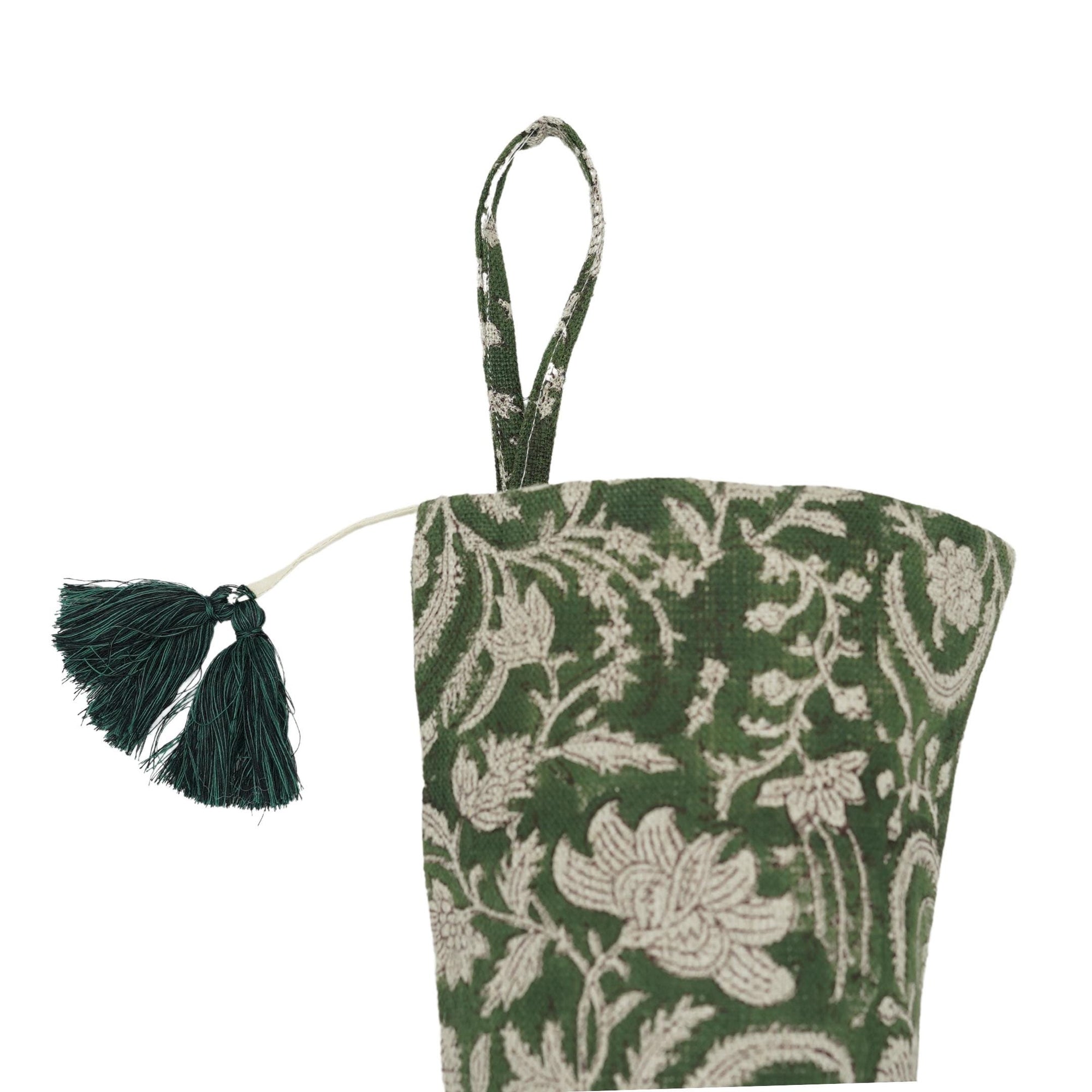 Green floral bag with tassel on white background.