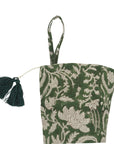 Green floral bag with tassel on white background.