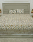 Discover the richness of Indian craftsmanship with this handmade cotton bedsheet and pillow cover. Wooden blocks imprint delicate floral patterns, creating a rustic yet elegant aesthetic. A beautiful blend of heritage and comfort for any space.