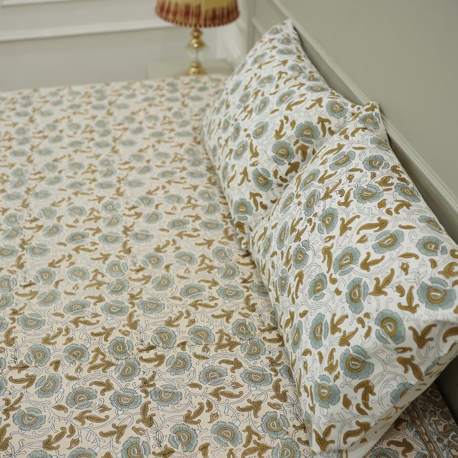 Infuse your bedroom with the delicate art of wooden block printing. This cotton bedsheet and pillow cover set showcases timeless floral patterns, hand-pressed to ensure authenticity and charm in every inch.