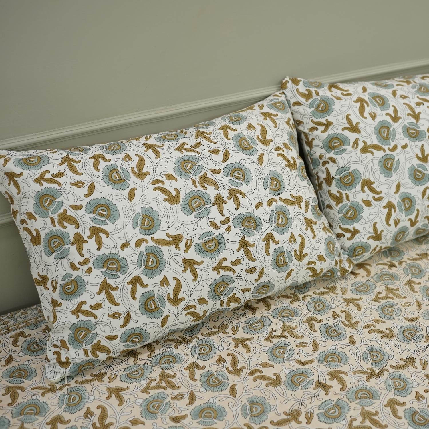 This hand block printed cotton bedsheet and pillow set is a statement in sustainable living. Natural dyes and floral designs create a calming aesthetic, offering handmade luxury with a touch of earthy elegance.
