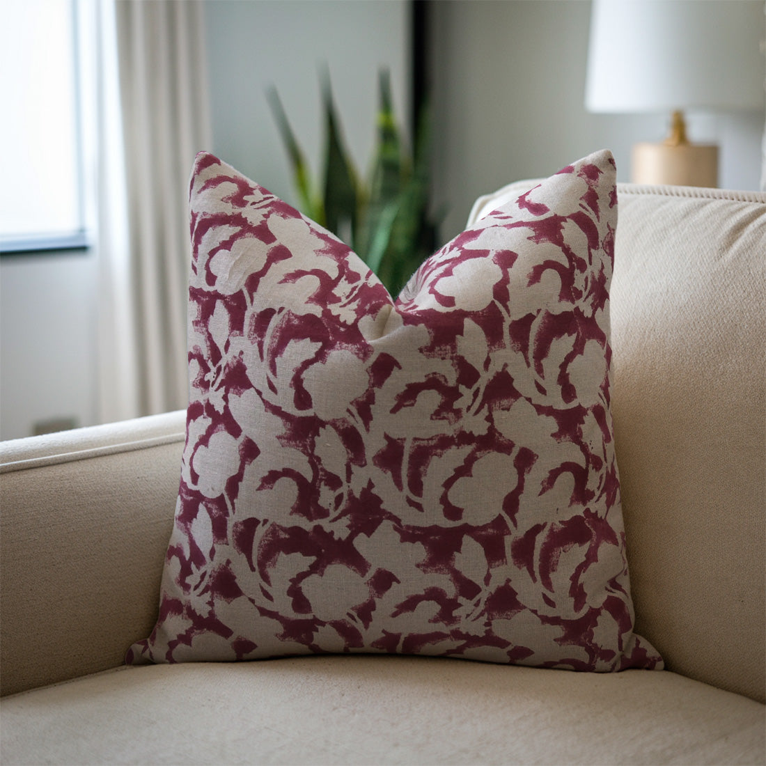 Brown pillow with a floral pattern on a beige sofa