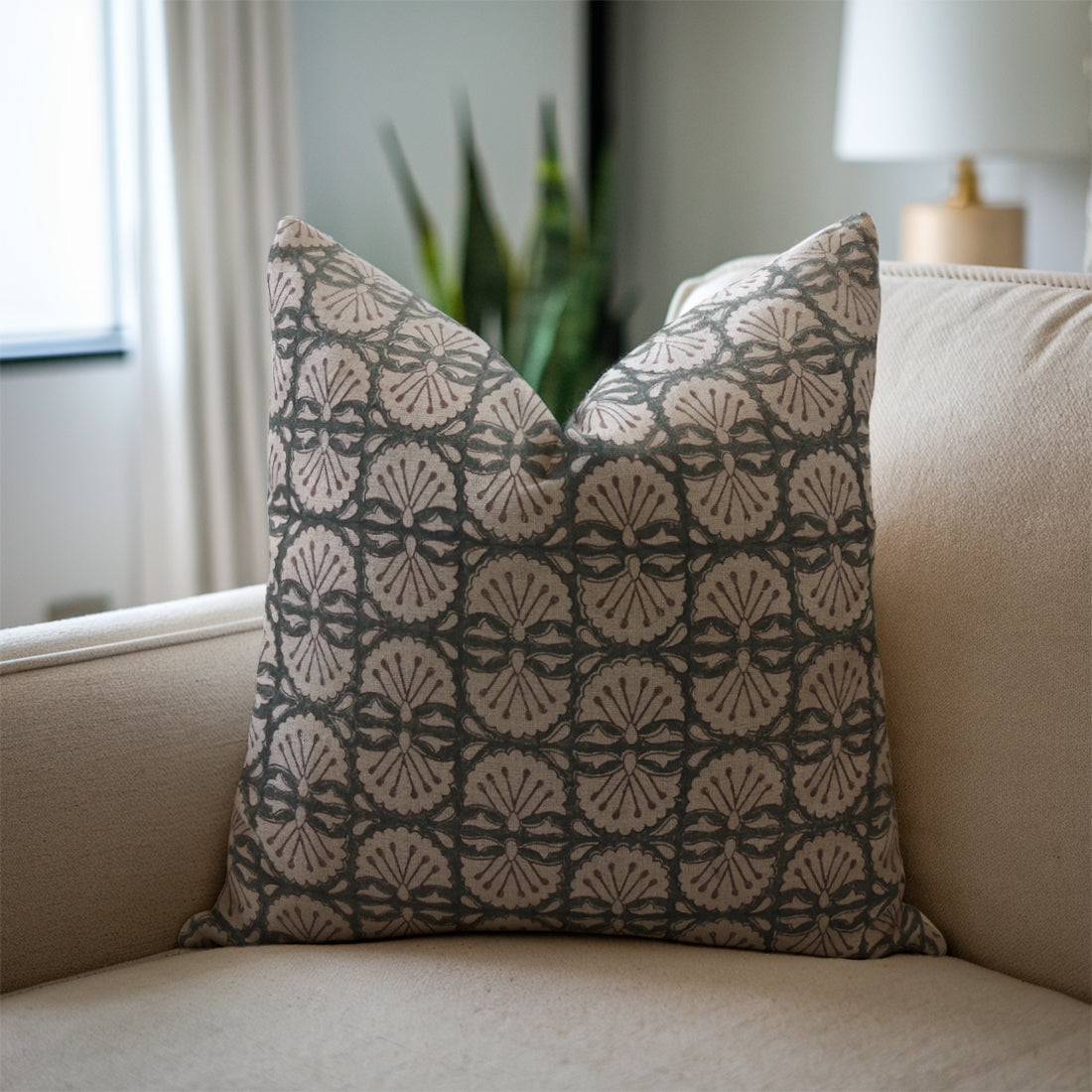Decorative pillow with geometric pattern on a beige sofa