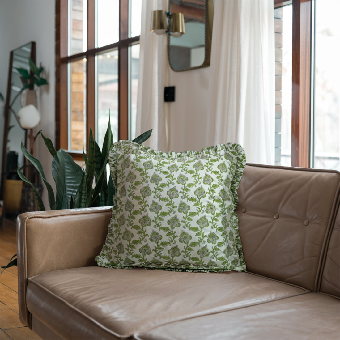 Cozy sofa accented with vibrant green frill linen pillow covers for style.