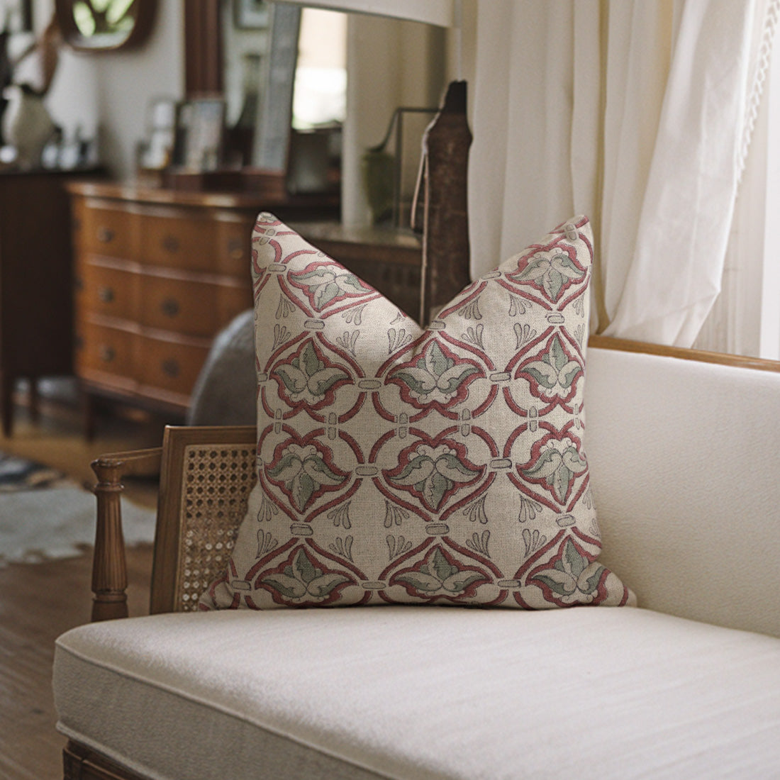 Handcrafted pillow with a geometric pattern on a white sofa in a room setting.
