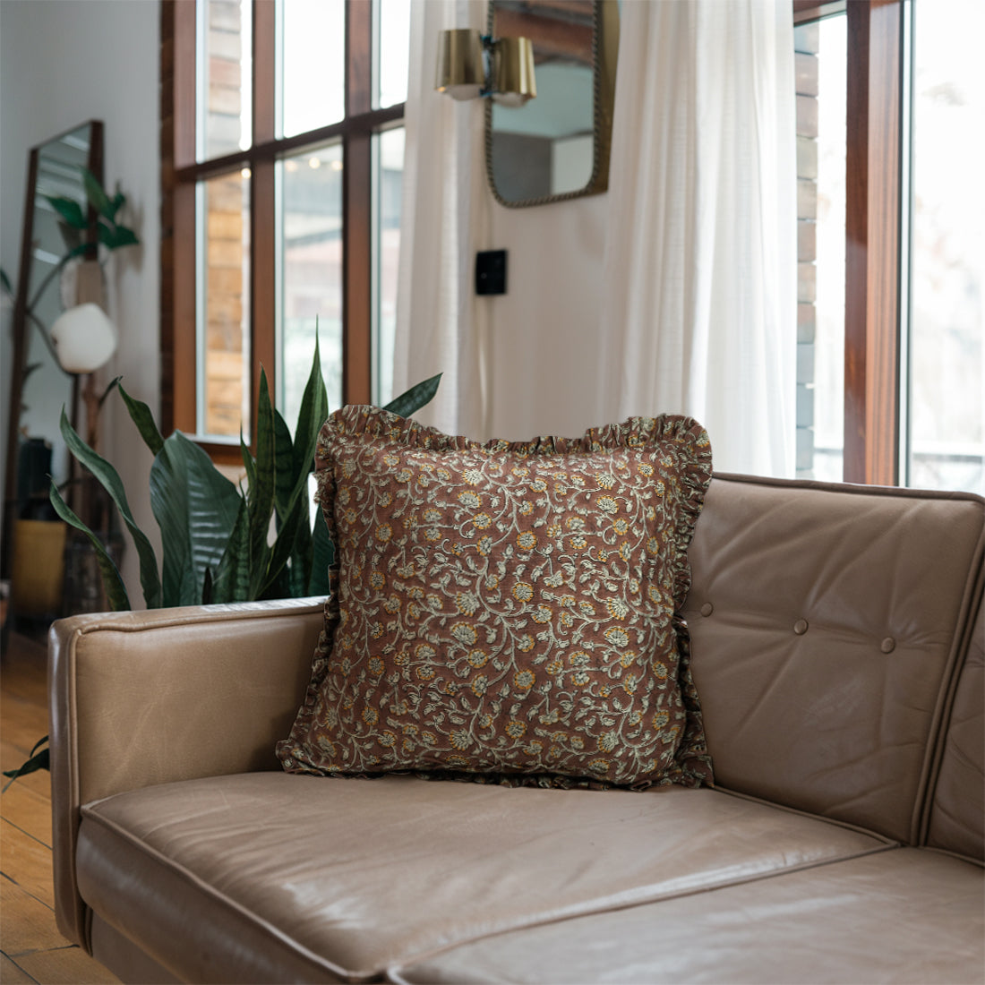 Beige sofa with stylish frill brown linen pillow covers, sunlit room 
