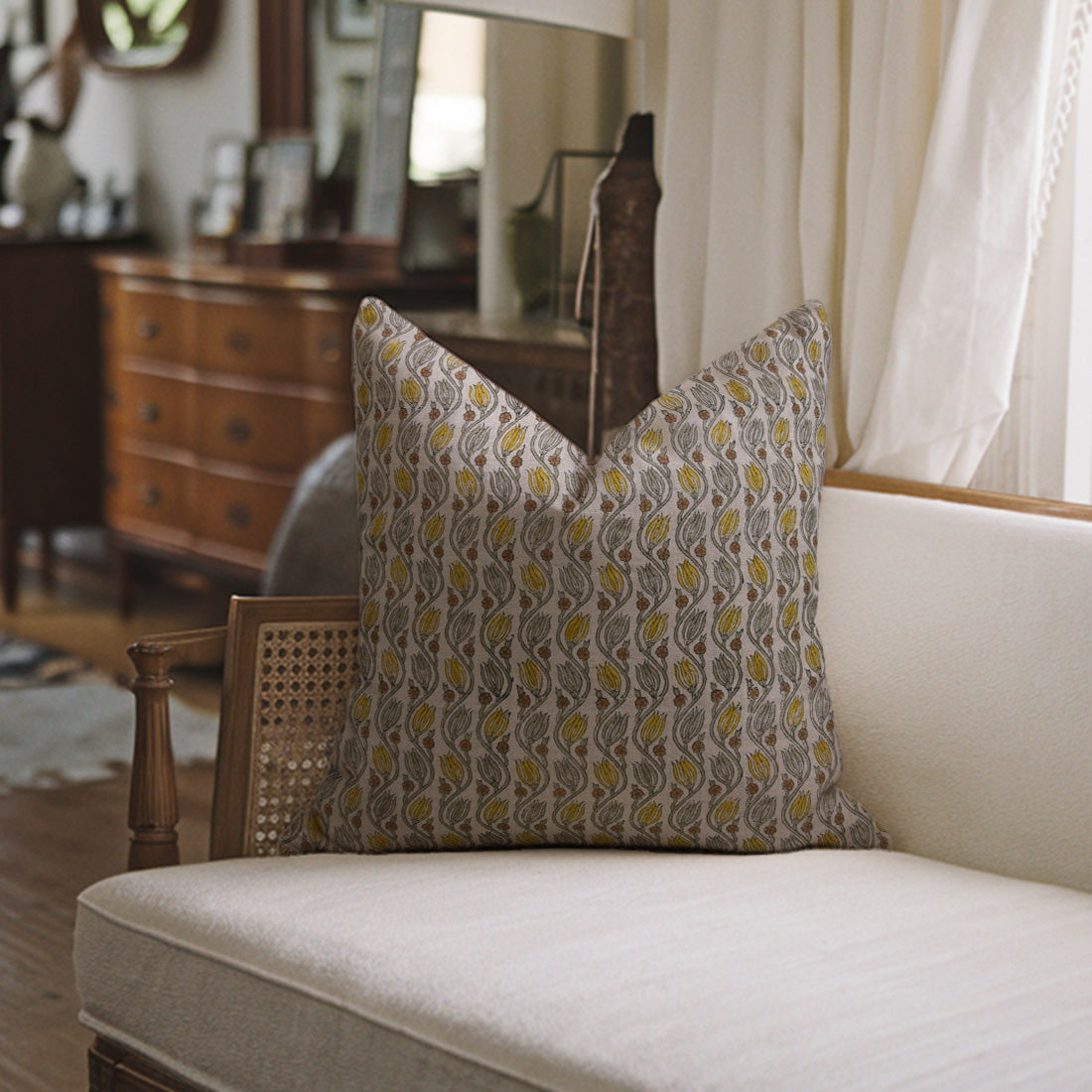 Patterned pillow on a white sofa featuring block print pillow covers.