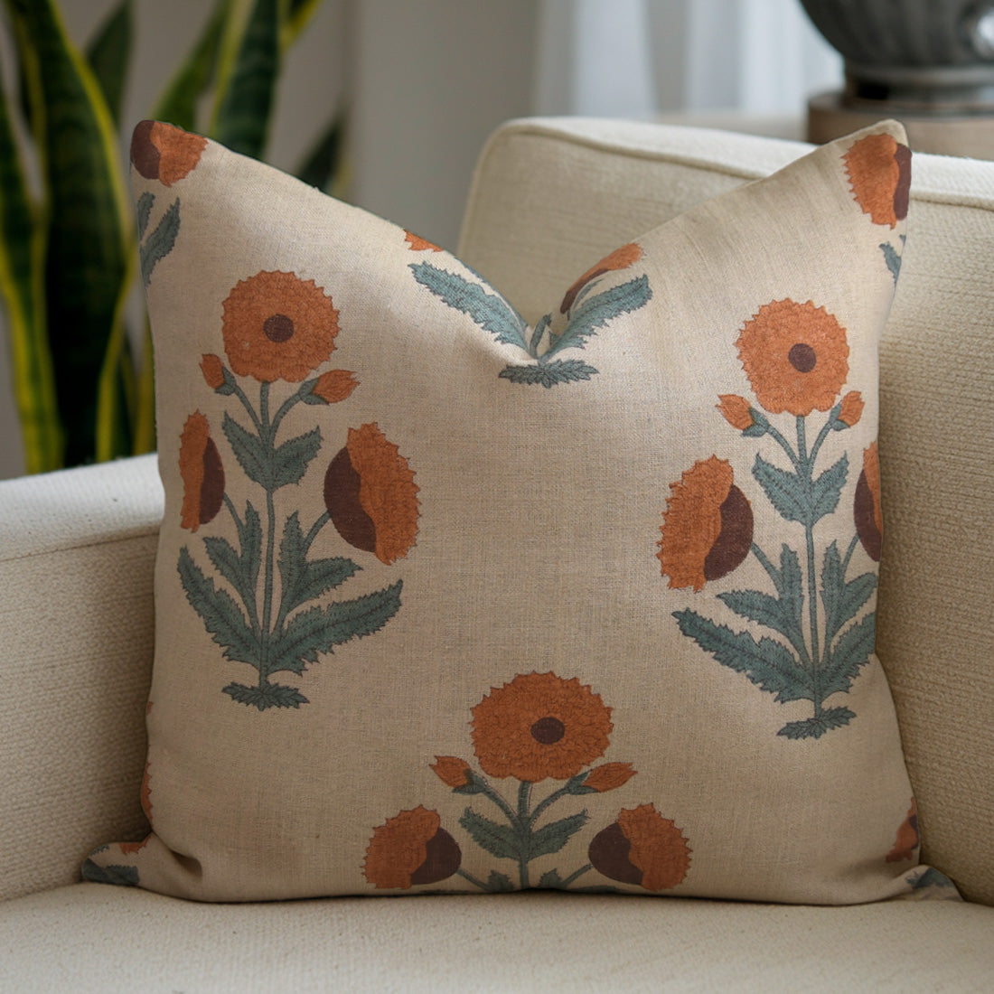 Decorative pillow with floral patterns on a beige couch