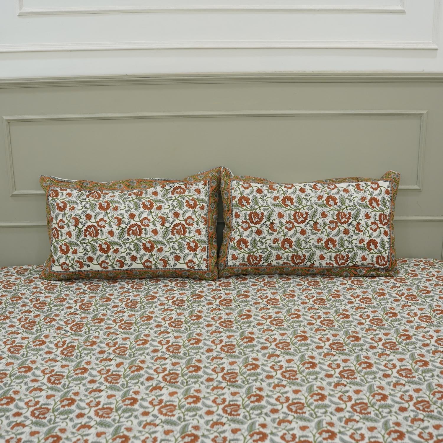 Elevate your space with bohemian elegance through this hand block printed cotton bedsheet set. Designed with intricate floral motifs and paired with pillow covers, this bedding brings handcrafted warmth and natural beauty into your room.