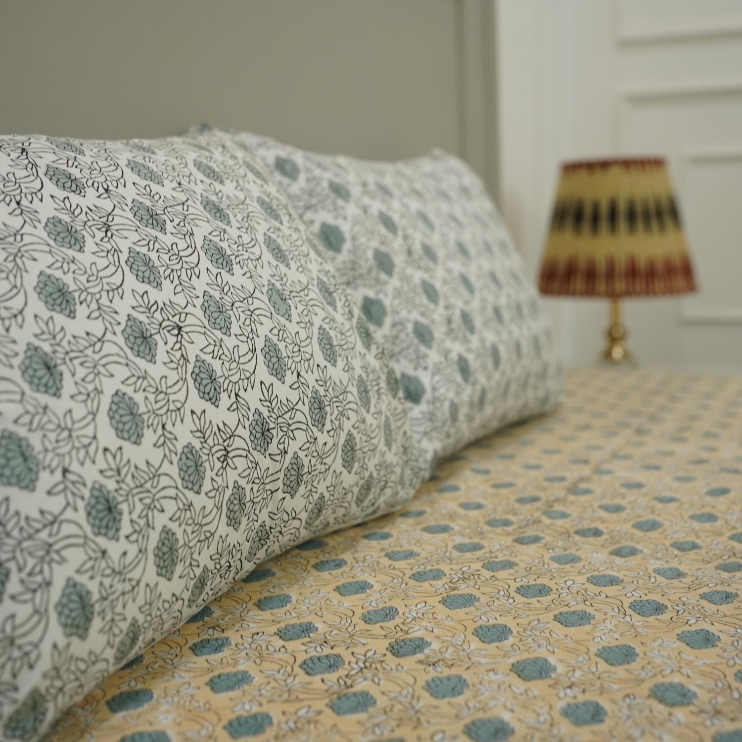 This hand block printed cotton bedsheet and pillow set is a statement in sustainable living. Natural dyes and floral designs create a calming aesthetic, offering handmade luxury with a touch of earthy elegance.