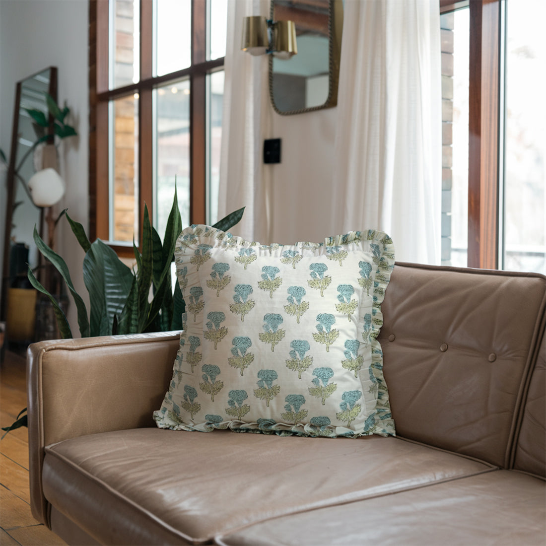 Cozy brown sofa accented with vibrant floral linen pillow covers in a stylish living room.