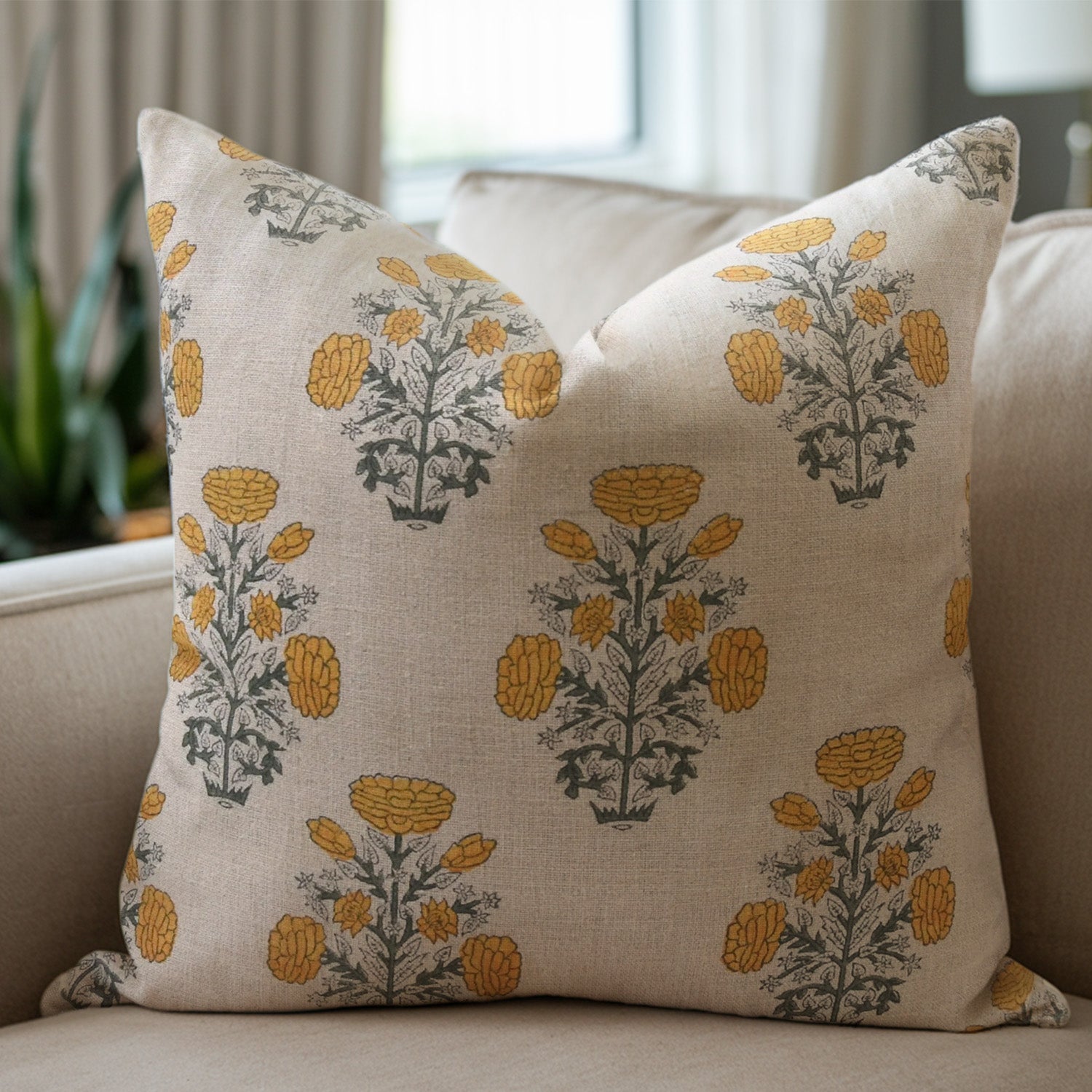 Linen pillow with floral pattern on a beige sofa