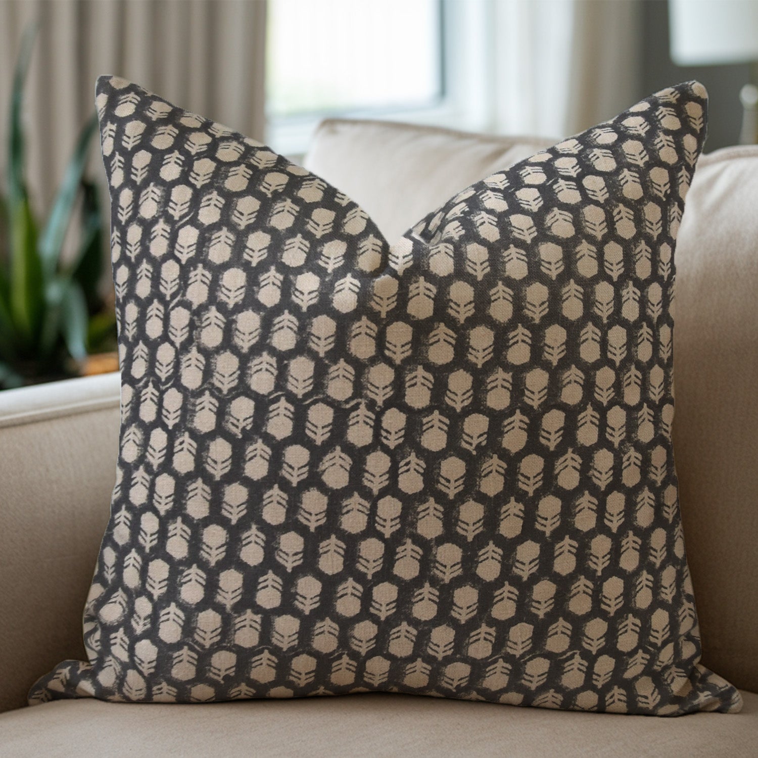 Bagru butti pillow with geometric pattern on a beige sofa