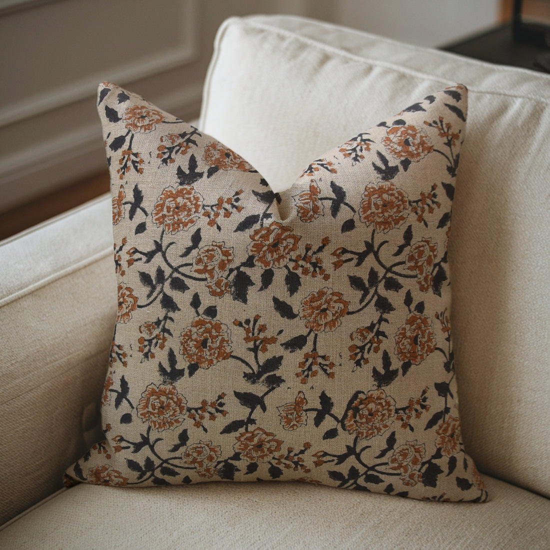 Floral-patterned pillow on a beige sofa