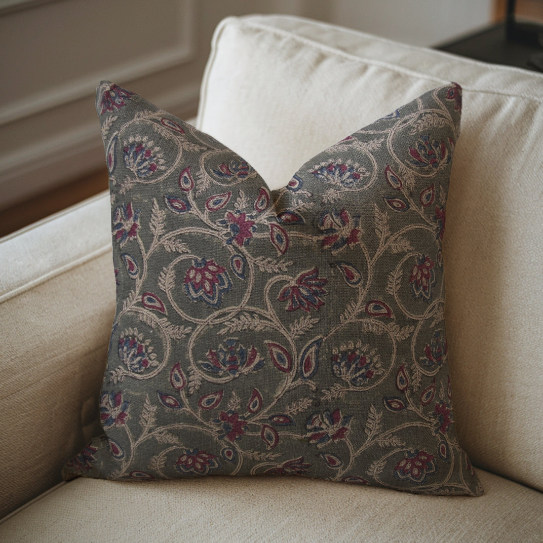 Decorative pillow with a floral pattern on a beige sofa, styled with pillow cover cushion.
