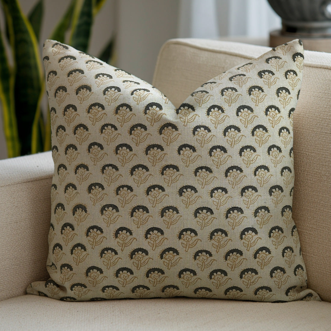 Decorative pillow with a floral pattern on a beige couch