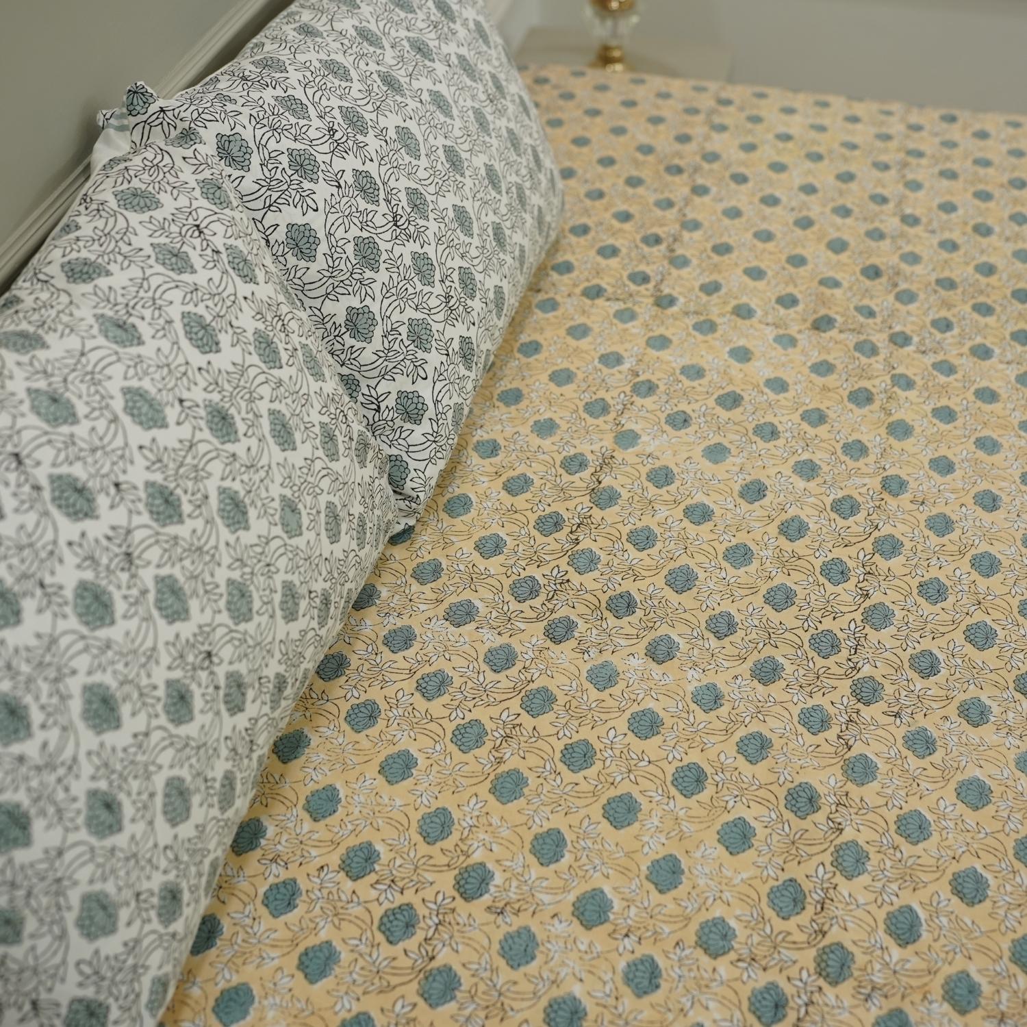 Crafted with care, this floral cotton bedsheet and pillow set features authentic hand block prints. Every piece reflects the spirit of bohemian decor with earthy tones, perfect for elevating your bedroom into a serene, artistic space.