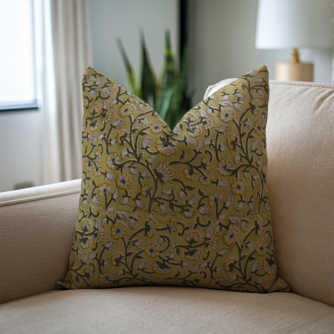 Block printed  pillow with floral pattern on a beige sofa