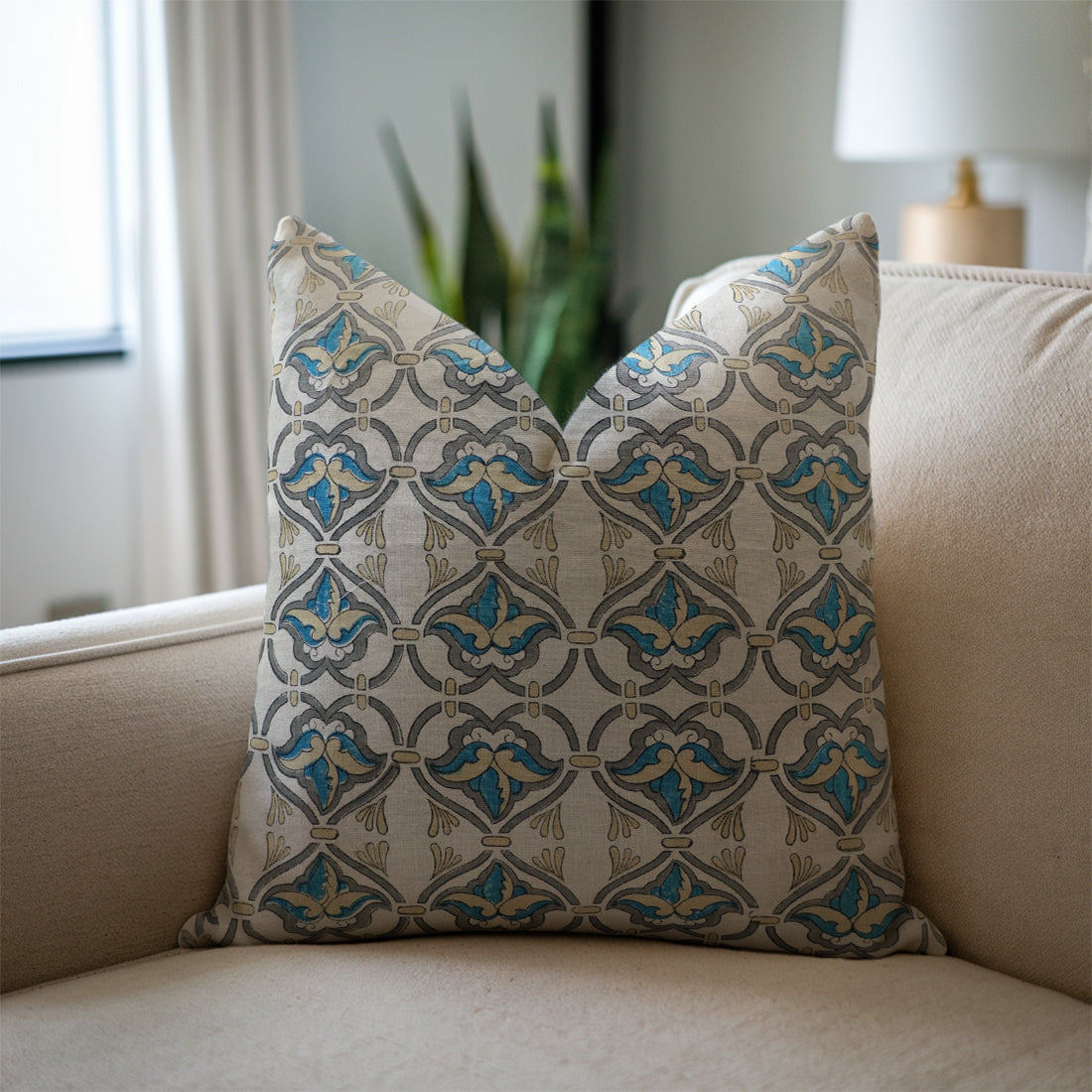 Decorative pillow with geometric pattern on a beige sofa
