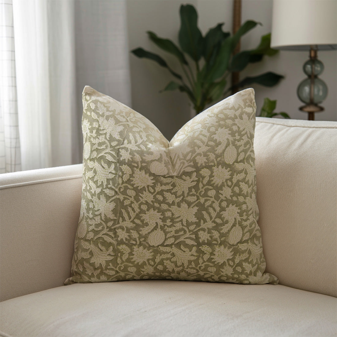 Decorative pillow with floral pattern on a beige sofa