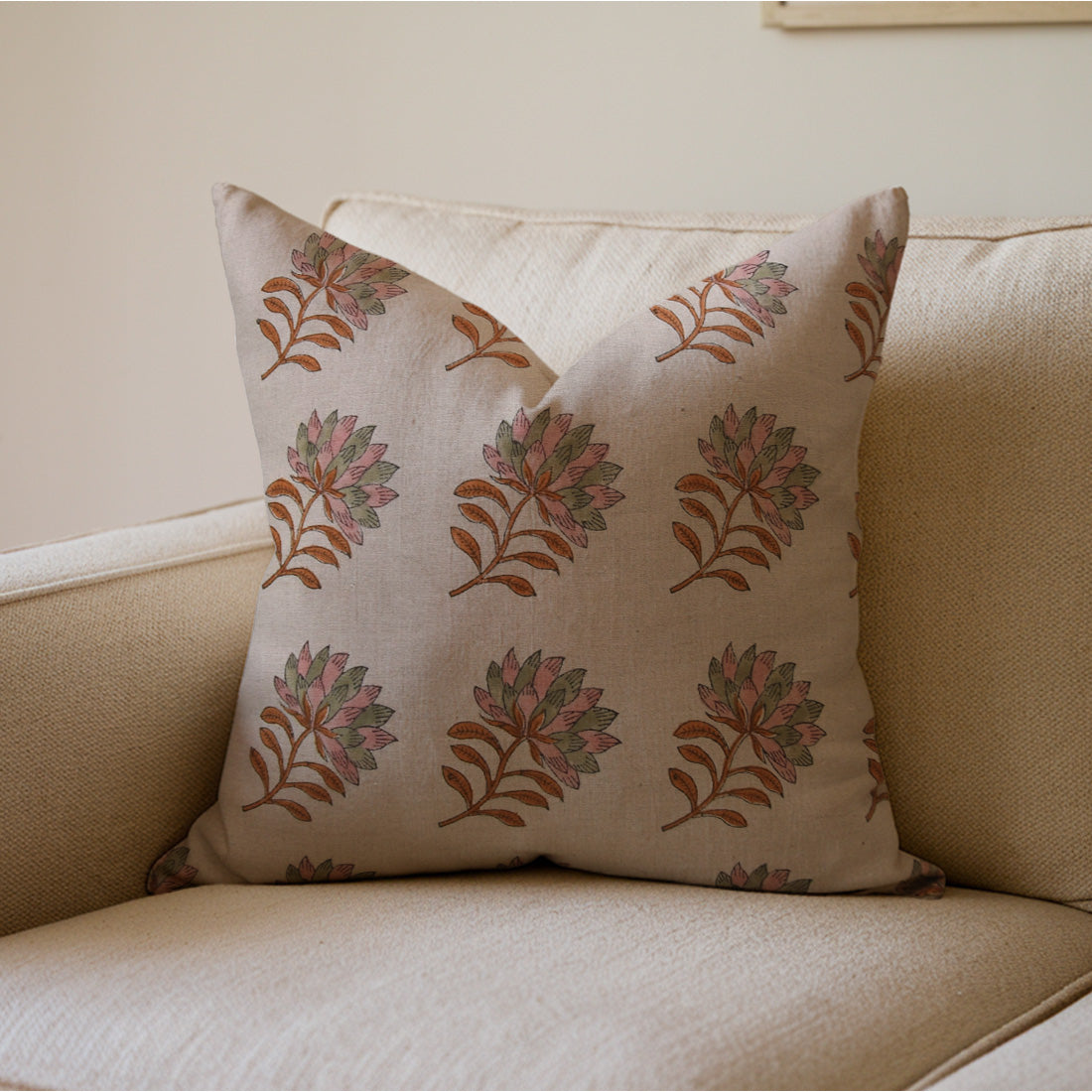 Decorative pillow with a floral pattern on a beige couch, styled with cushion pillow covers.